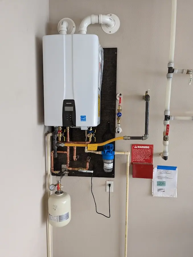 Professional plumber installing copper piping in a Burtonsville home